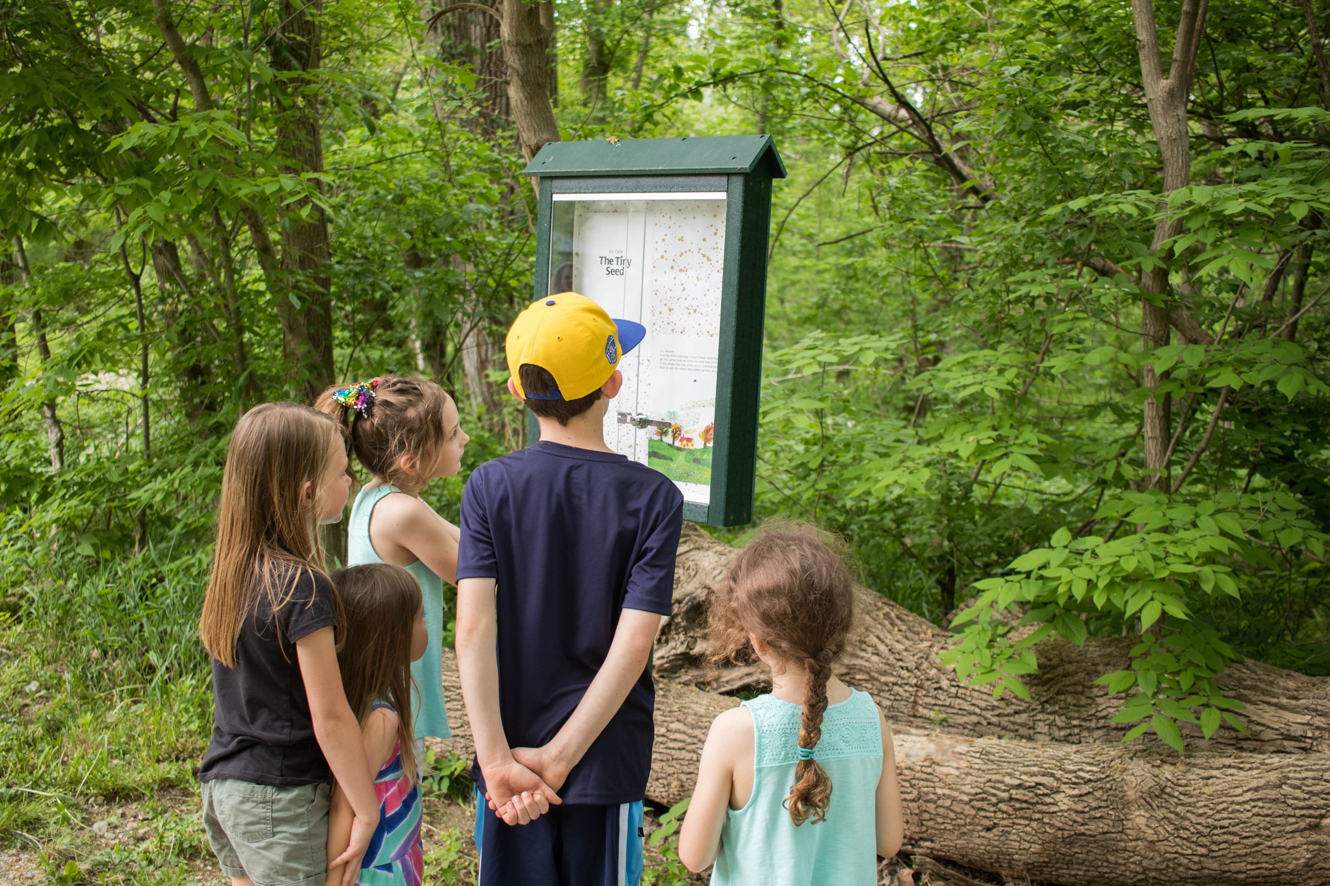 Kids read story at Storywalk and Arbuckle Acres Park