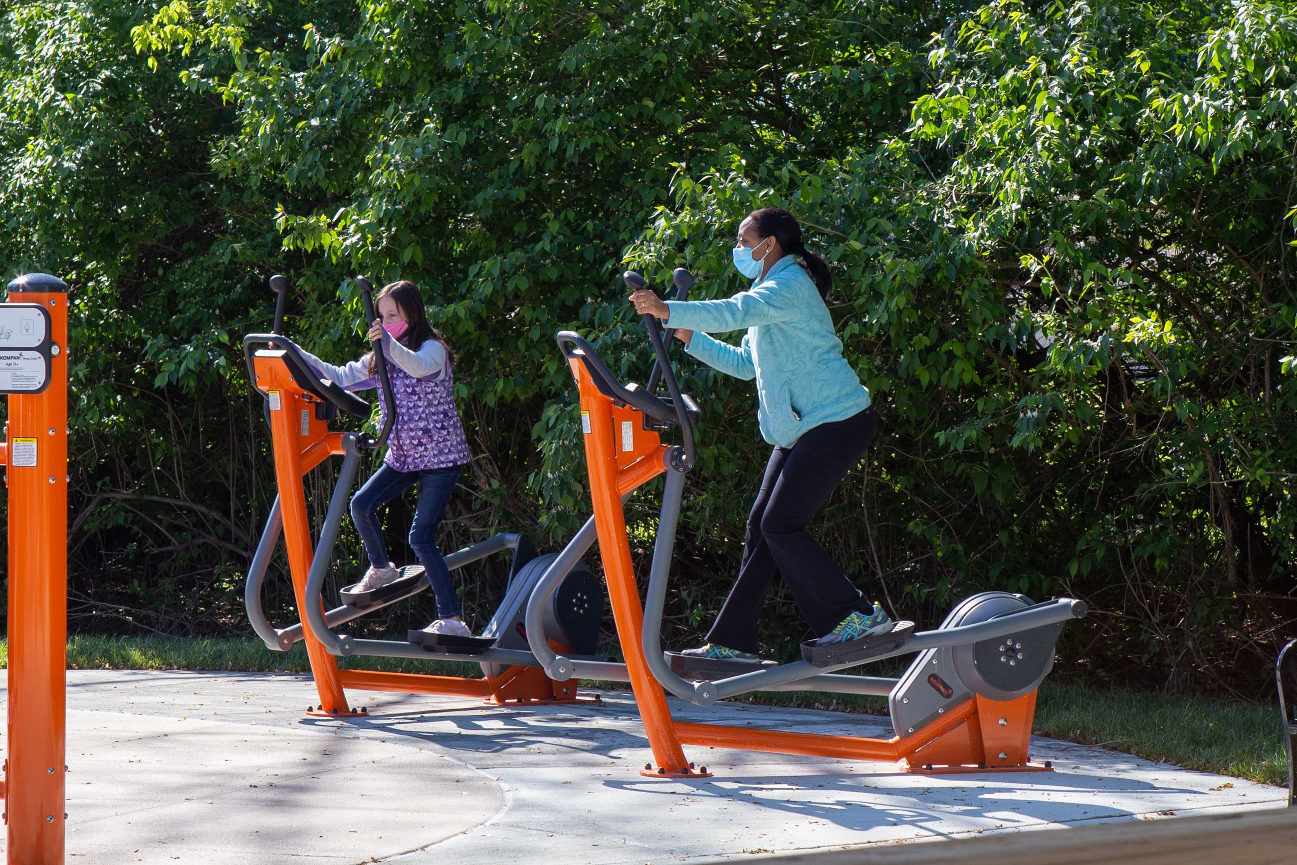 People using outdoor exercise equipment at Stephens Park