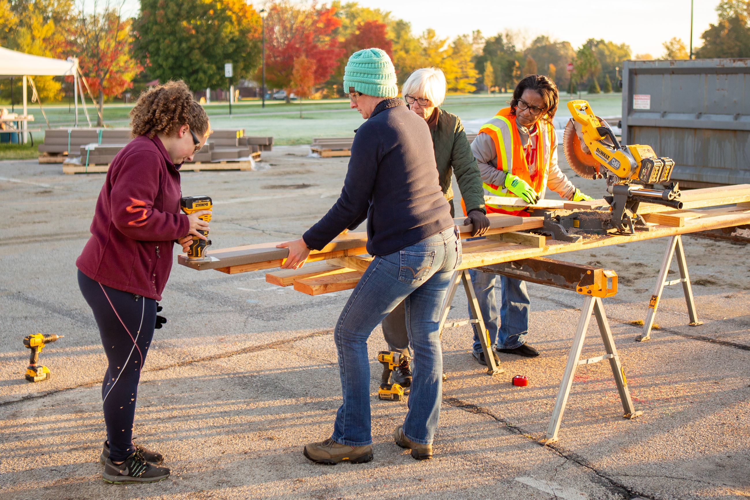 Volunteer group uses a router on a board 