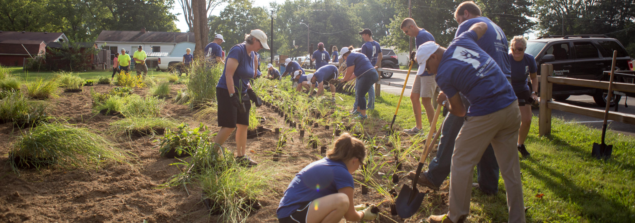 Volunteers from IU Health West Hospital help plant a pollinator garden at the Outdoor Classroom